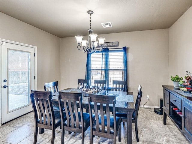 dining room featuring visible vents, baseboards, and an inviting chandelier