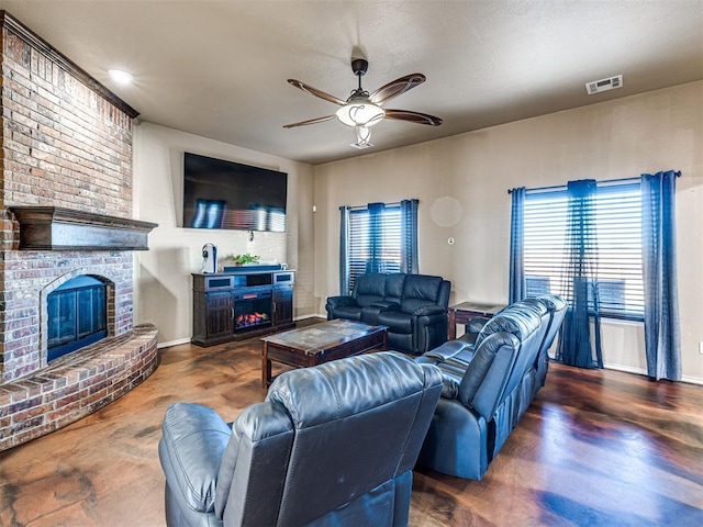 living area featuring a brick fireplace, a ceiling fan, visible vents, and baseboards