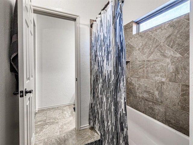 full bath featuring shower / bathtub combination with curtain and baseboards