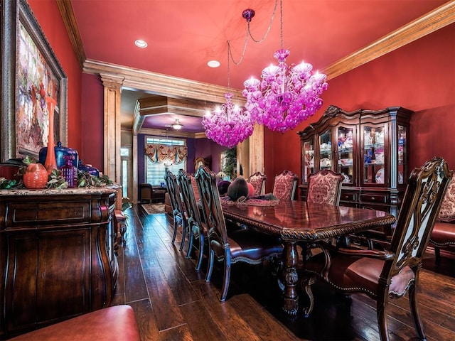 dining area with ornate columns, dark wood-type flooring, a chandelier, and ornamental molding