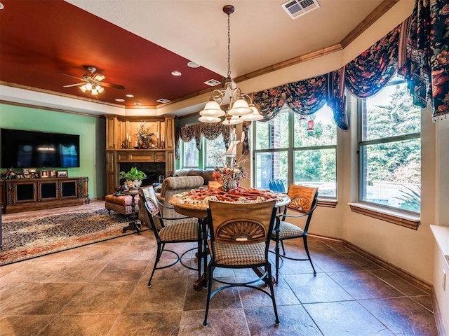 dining area featuring ceiling fan with notable chandelier and ornamental molding