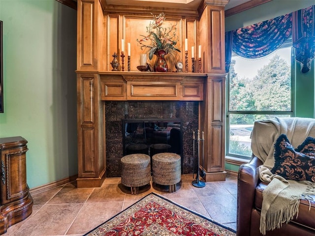 living area featuring a tiled fireplace