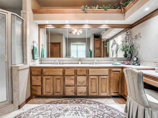 bathroom with ceiling fan, walk in shower, tile patterned flooring, crown molding, and vanity