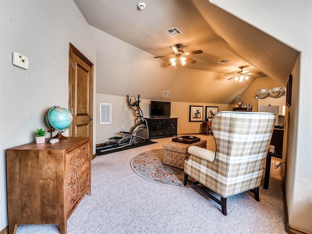 sitting room with ceiling fan, light colored carpet, and vaulted ceiling