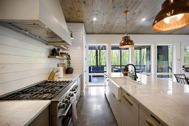 kitchen featuring light stone countertops, premium range hood, stainless steel stove, wood walls, and wood ceiling