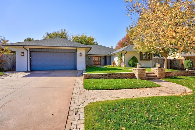 ranch-style house featuring a front yard and a garage