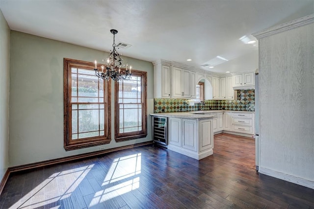 kitchen with an inviting chandelier, decorative backsplash, dark hardwood / wood-style floors, decorative light fixtures, and wine cooler