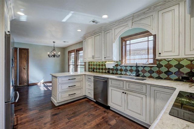 kitchen featuring sink, hanging light fixtures, stainless steel appliances, and tasteful backsplash