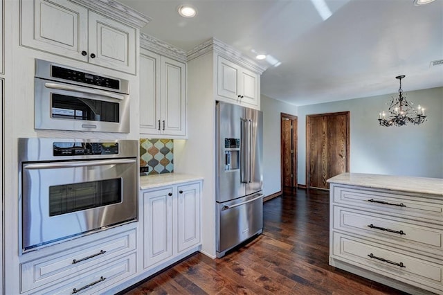 kitchen featuring backsplash, dark hardwood / wood-style floors, high quality fridge, white cabinetry, and a chandelier