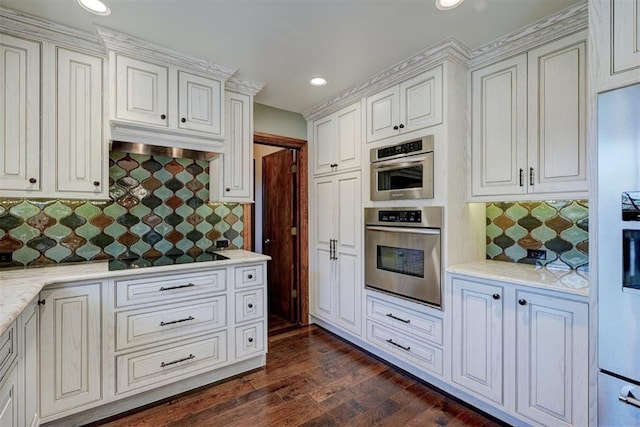 kitchen featuring light stone countertops, decorative backsplash, dark hardwood / wood-style flooring, and white cabinetry