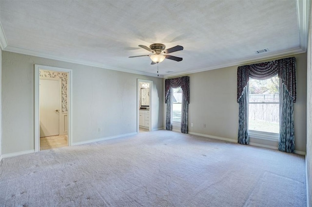 empty room featuring ceiling fan, ornamental molding, and light colored carpet