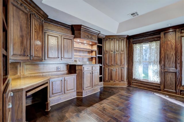 kitchen featuring dark hardwood / wood-style floors and a tray ceiling