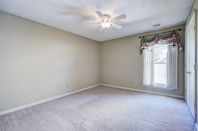 carpeted spare room with ceiling fan