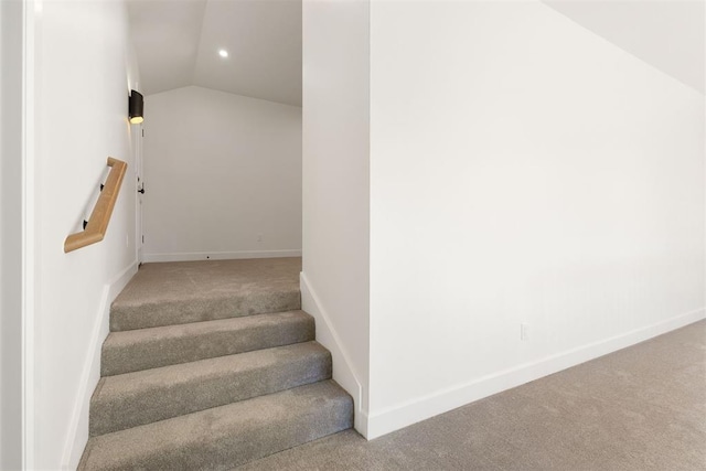 staircase with carpet and lofted ceiling