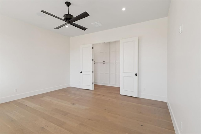 unfurnished bedroom with ceiling fan, light hardwood / wood-style flooring, and a closet