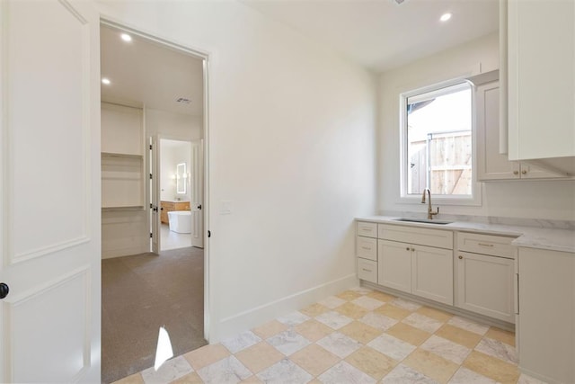 kitchen with sink and white cabinetry