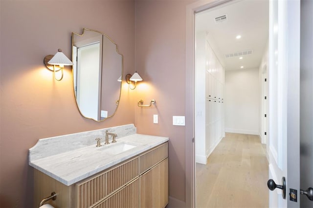 bathroom with hardwood / wood-style flooring and vanity