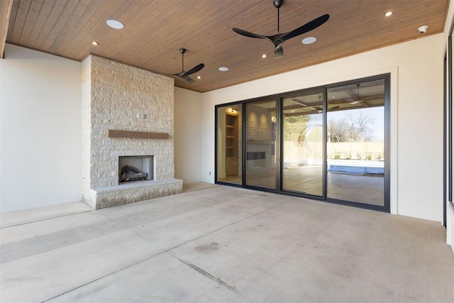 view of patio / terrace with ceiling fan and a stone fireplace