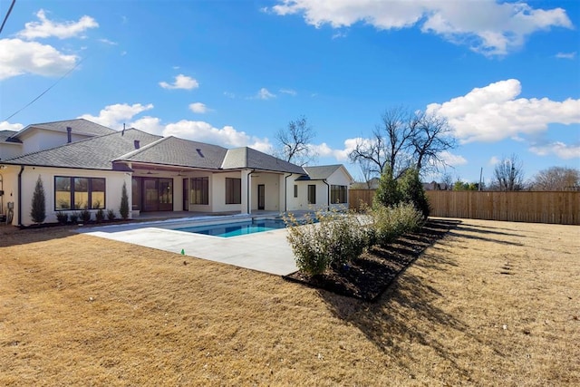 exterior space with a patio area, a fenced in pool, and a yard