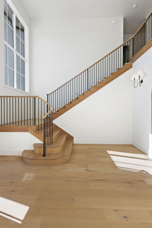 stairway with hardwood / wood-style floors