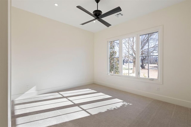 carpeted spare room featuring ceiling fan