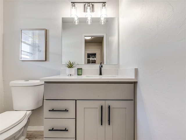 bathroom with vanity and toilet