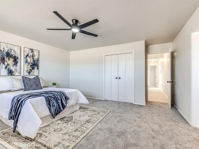 bedroom featuring a closet, ceiling fan, and light carpet