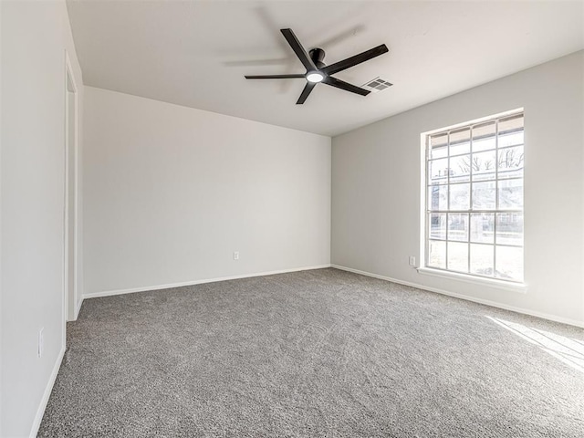 empty room featuring carpet floors and ceiling fan