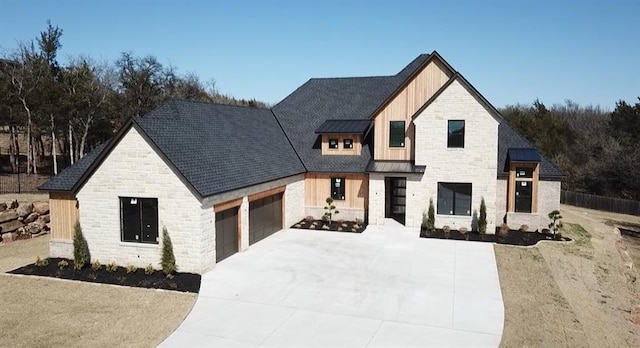 modern farmhouse style home featuring a garage, concrete driveway, metal roof, and a standing seam roof