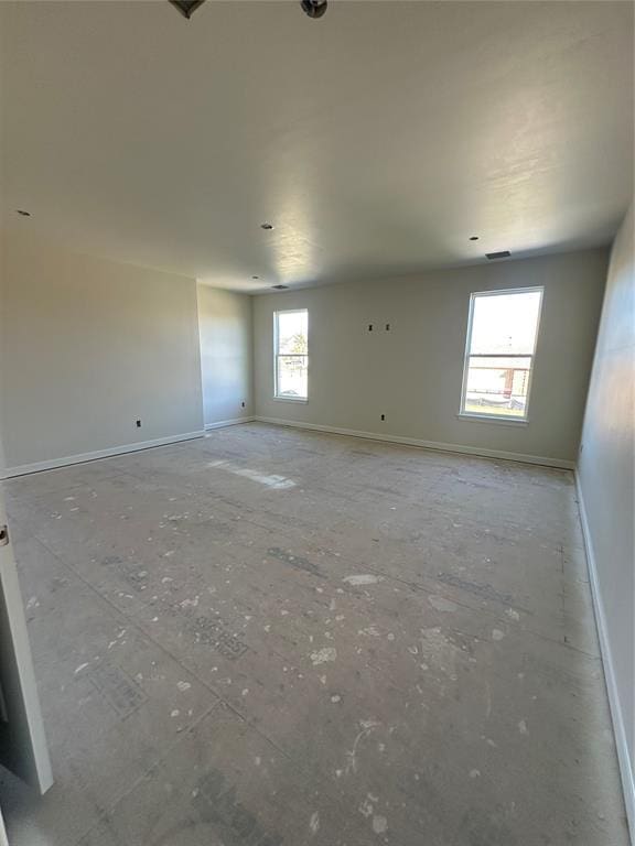 empty room with visible vents and baseboards