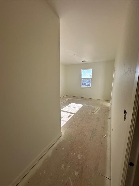 empty room featuring baseboards