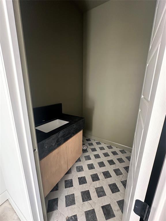 bathroom featuring baseboards and vanity