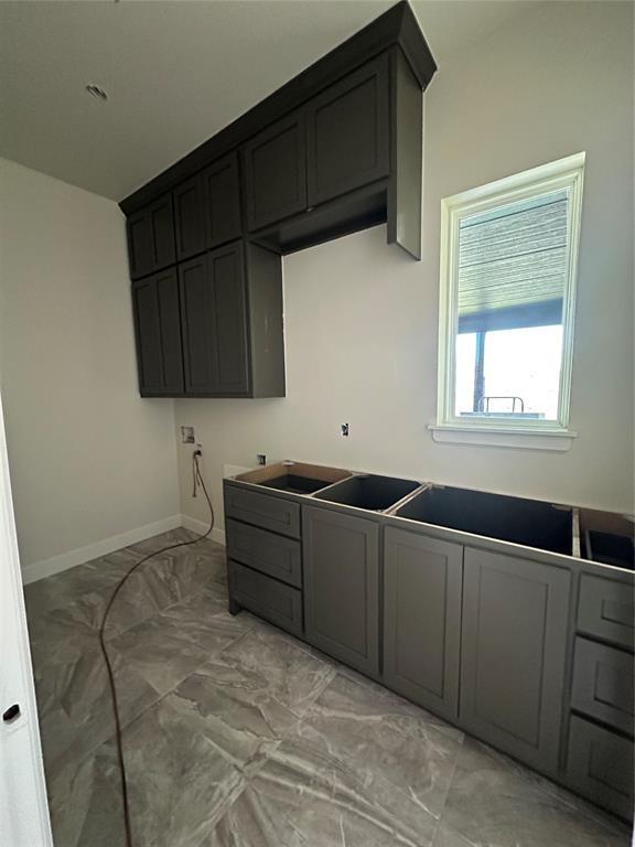 kitchen featuring baseboards and marble finish floor