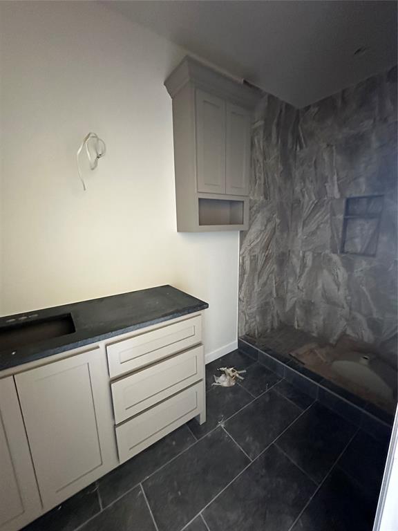 bathroom featuring tile patterned floors and a shower