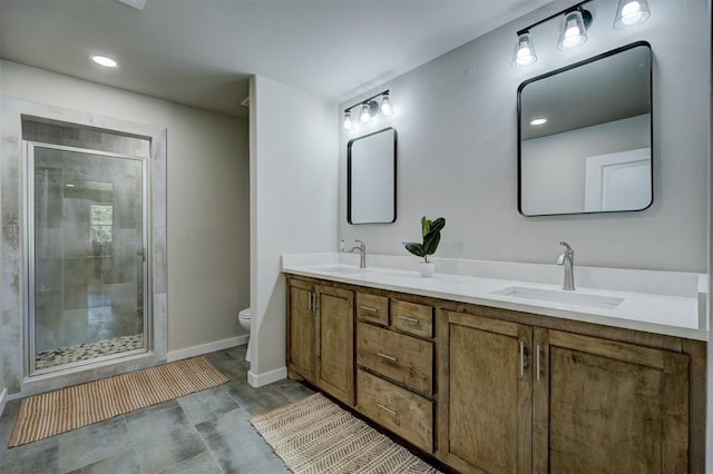 bathroom with a shower with door, vanity, and toilet