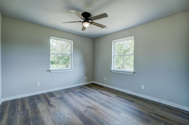 spare room with ceiling fan and dark wood-type flooring