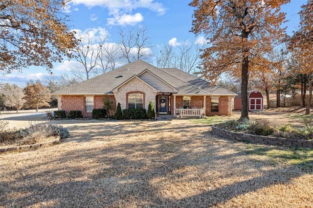 ranch-style house with a storage unit