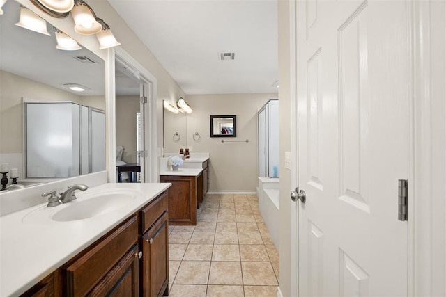 bathroom with tile patterned flooring, vanity, and walk in shower