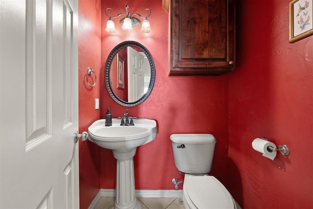 bathroom with toilet and tile patterned floors