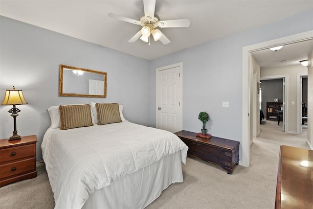 bedroom featuring ceiling fan and light colored carpet