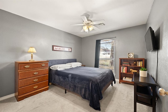 bedroom with light carpet and ceiling fan