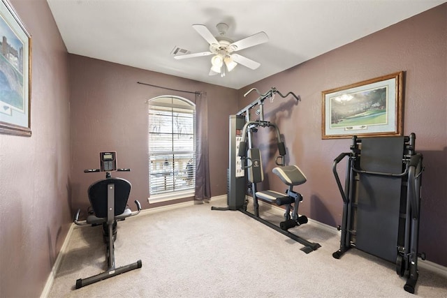 workout room featuring ceiling fan and light carpet