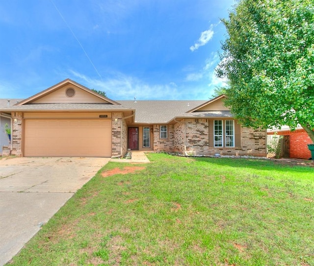 ranch-style home with a garage and a front lawn