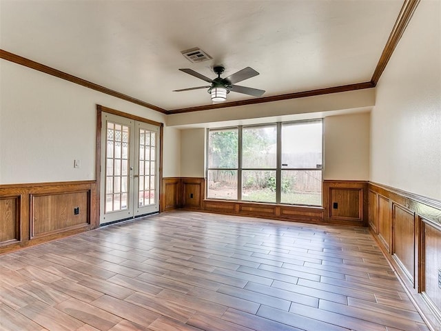 unfurnished room featuring ceiling fan, french doors, and crown molding