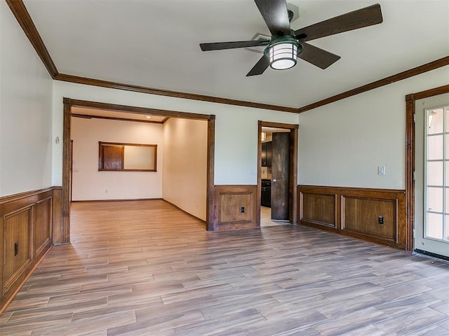 spare room with ceiling fan, light hardwood / wood-style floors, and ornamental molding