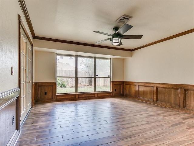 empty room with crown molding and ceiling fan