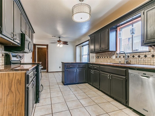 kitchen featuring decorative backsplash, appliances with stainless steel finishes, ceiling fan, sink, and light tile patterned flooring