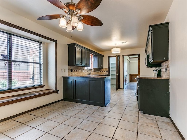 kitchen featuring sink, decorative backsplash, ceiling fan, light tile patterned floors, and decorative light fixtures