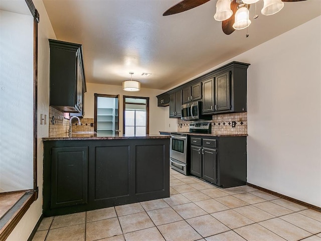 kitchen with backsplash, sink, ceiling fan, light tile patterned floors, and stainless steel appliances