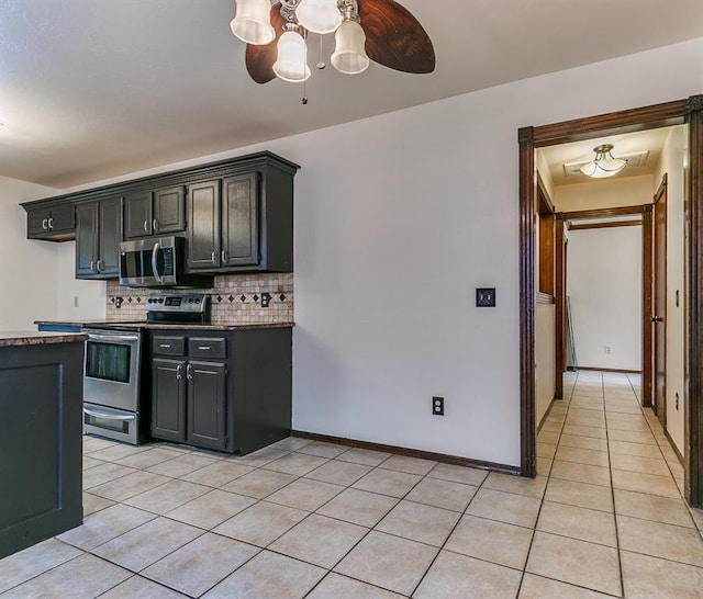 kitchen featuring ceiling fan, light tile patterned floors, stainless steel appliances, and tasteful backsplash